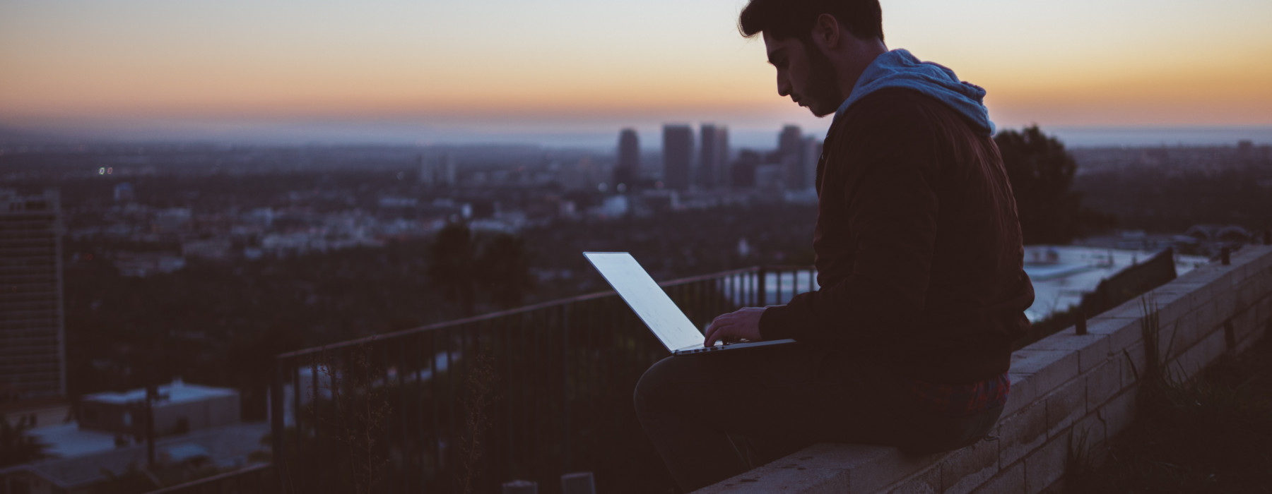 man sitting with computer - keeping our brains healthy