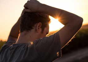 Man with arms up in sun