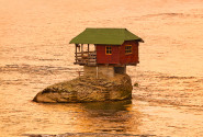 Openground House on rock island in river