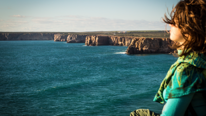 Woman in green near ocean edit